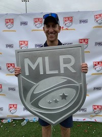 Kevin Alschuler, PhD, holding 2019 Major League Rugby championship trophy