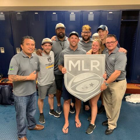 Kevin Alschuler, PhD, with the coaching and medical staff of the Seattle Seawolves holding the 2019 Major League Rugby Championship trophy